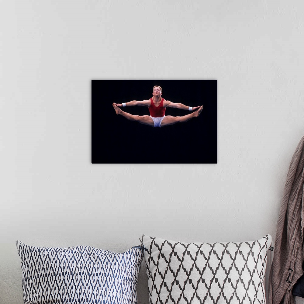 A bohemian room featuring Male gymnast performing on the floor exercise