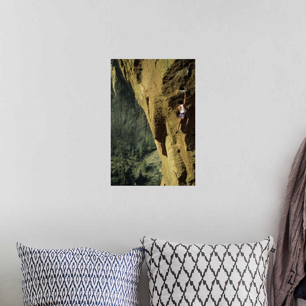 A bohemian room featuring Male rock climber scaling rock face in Smith Rock, Oregon, USA,