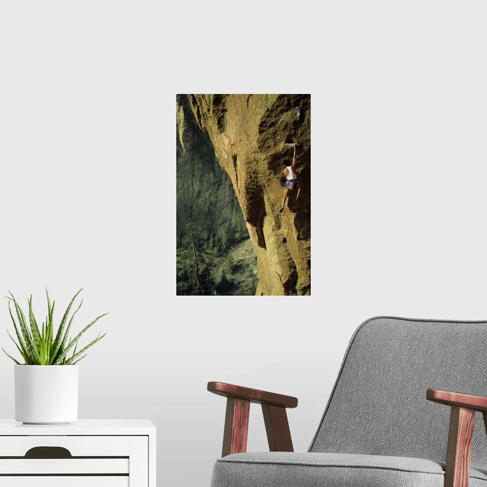 A modern room featuring Male rock climber scaling rock face in Smith Rock, Oregon, USA,