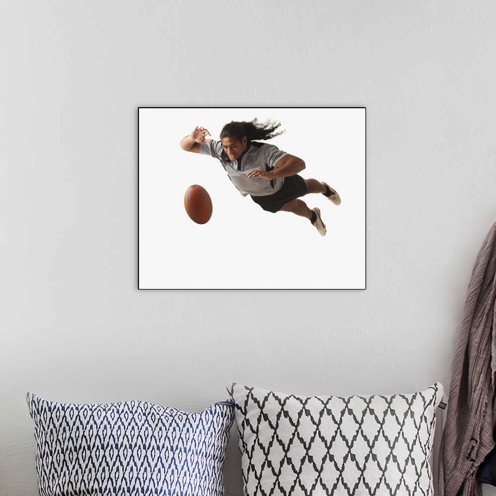 A bohemian room featuring Male rugby player diving for ball