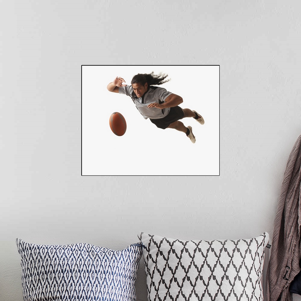 A bohemian room featuring Male rugby player diving for ball