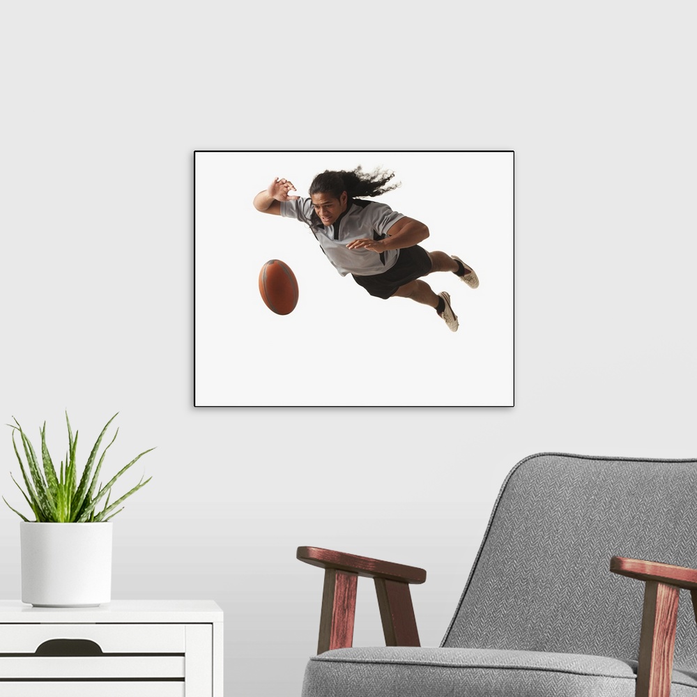 A modern room featuring Male rugby player diving for ball