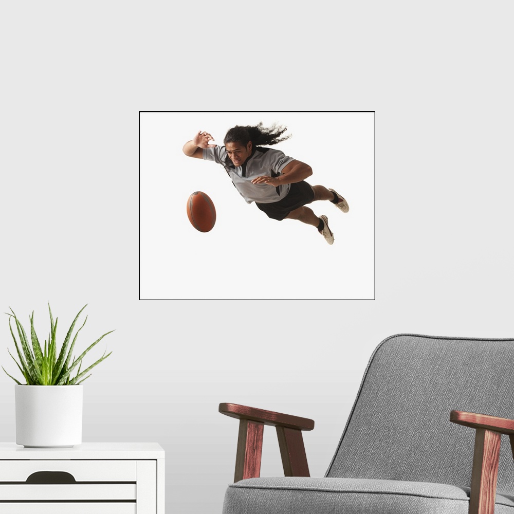 A modern room featuring Male rugby player diving for ball