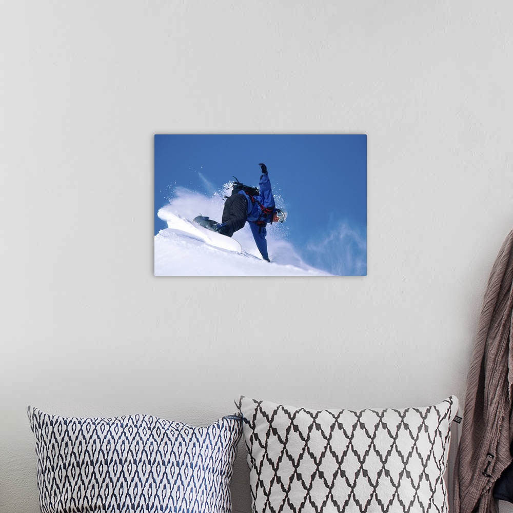 A bohemian room featuring Male snowboarder leaning into slope, low angle view