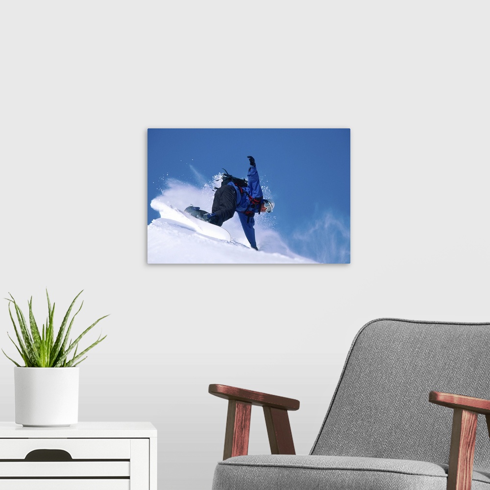 A modern room featuring Male snowboarder leaning into slope, low angle view