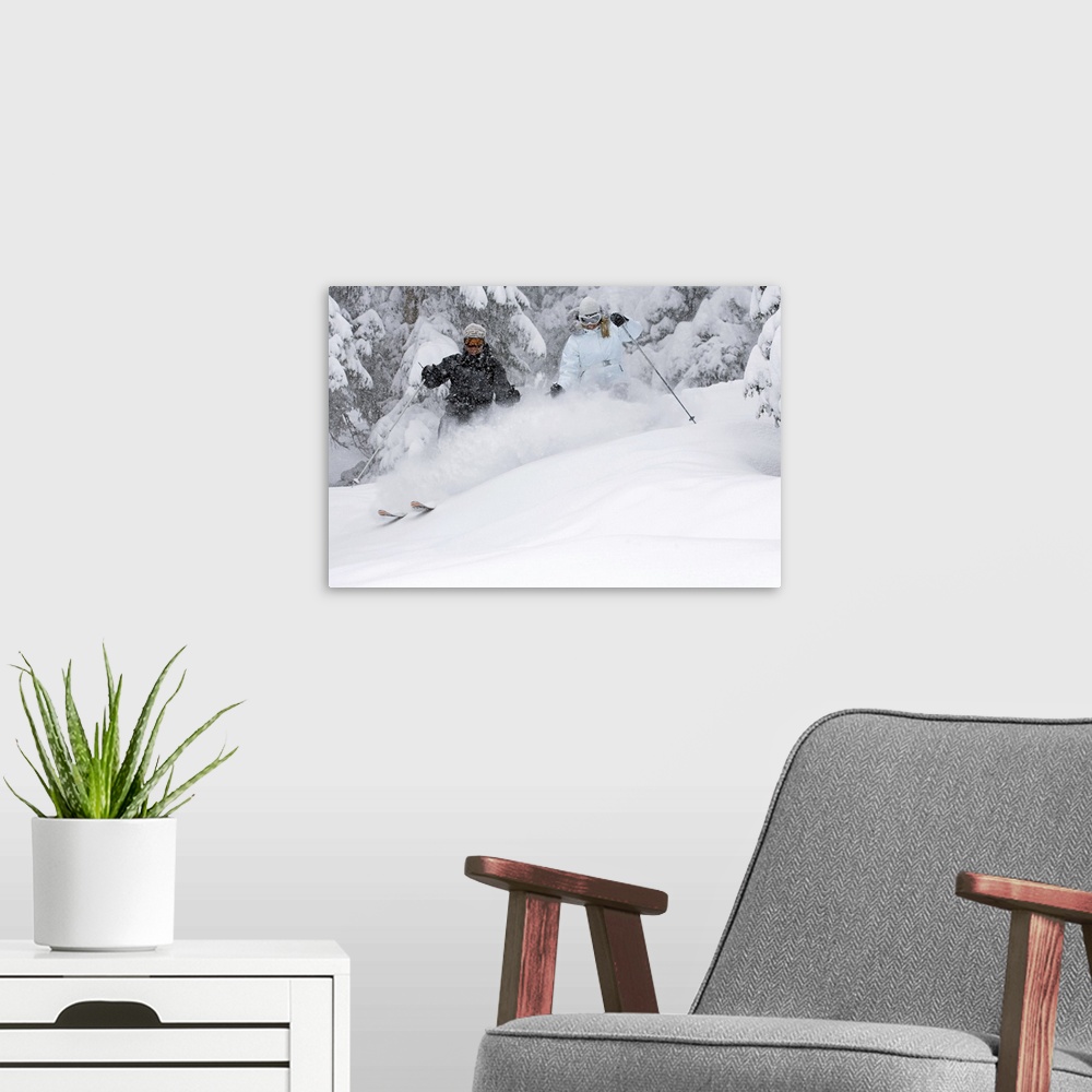 A modern room featuring Man and woman snow skiing