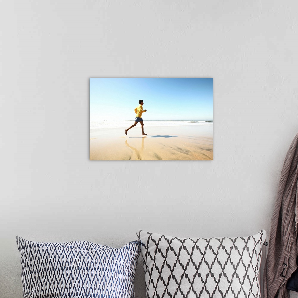 A bohemian room featuring Man jogging on beach
