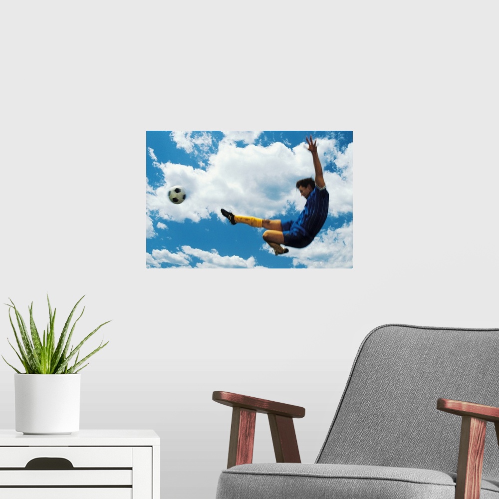 A modern room featuring Man kicking soccer ball