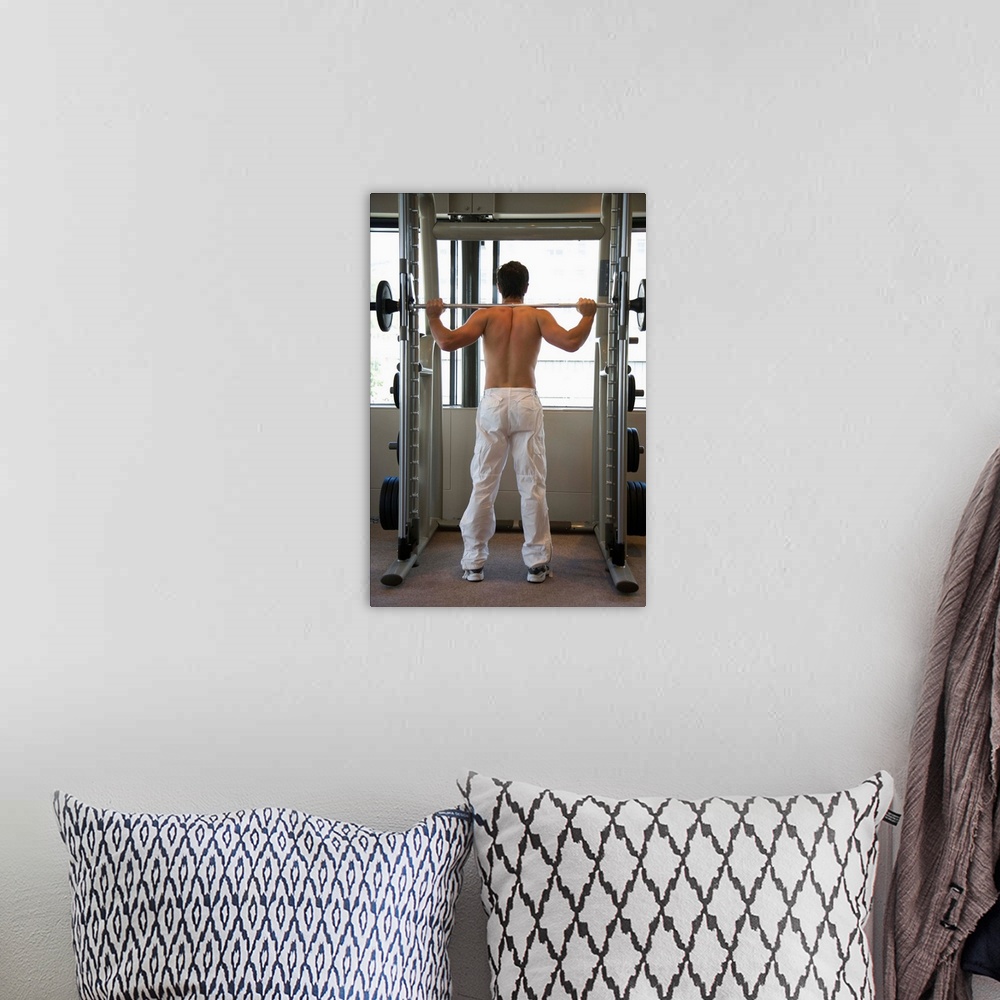 A bohemian room featuring Man lifting barbell