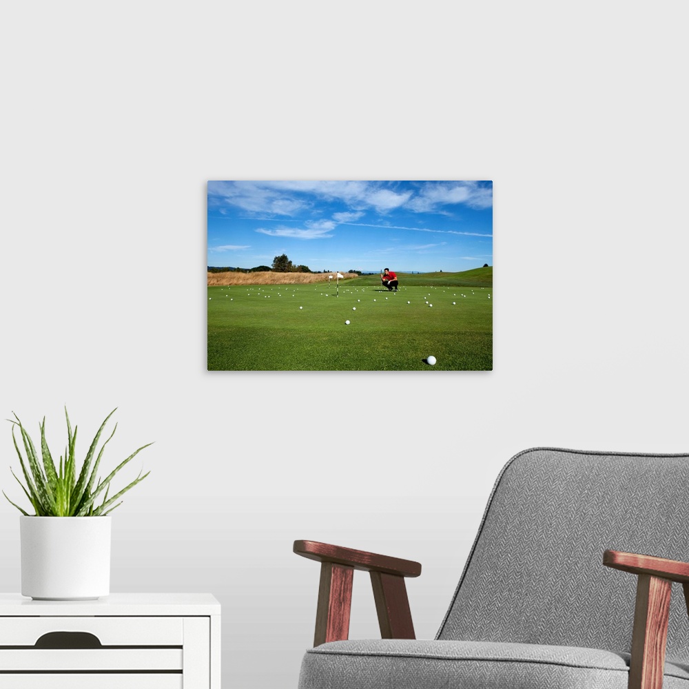 A modern room featuring Man lining up a putt while golfing.
