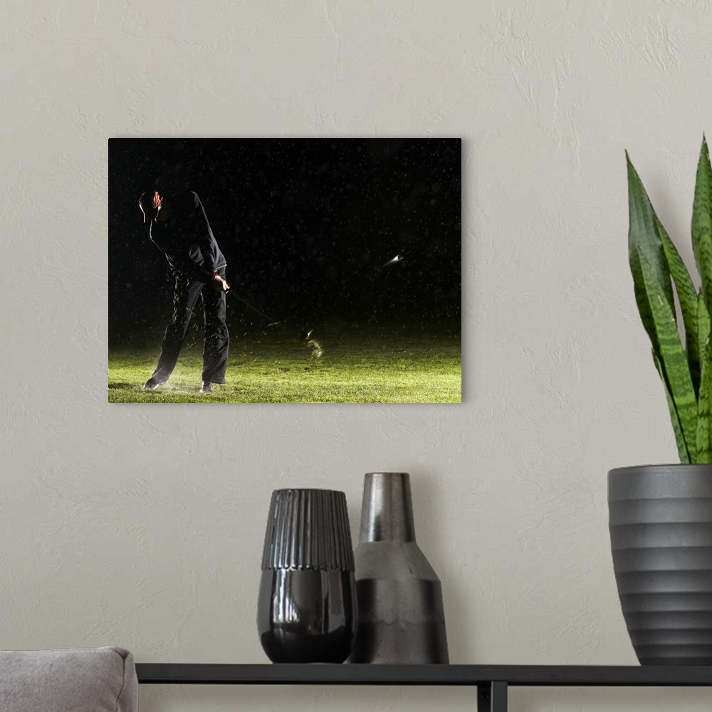 A modern room featuring Man playing golf, hitting ball