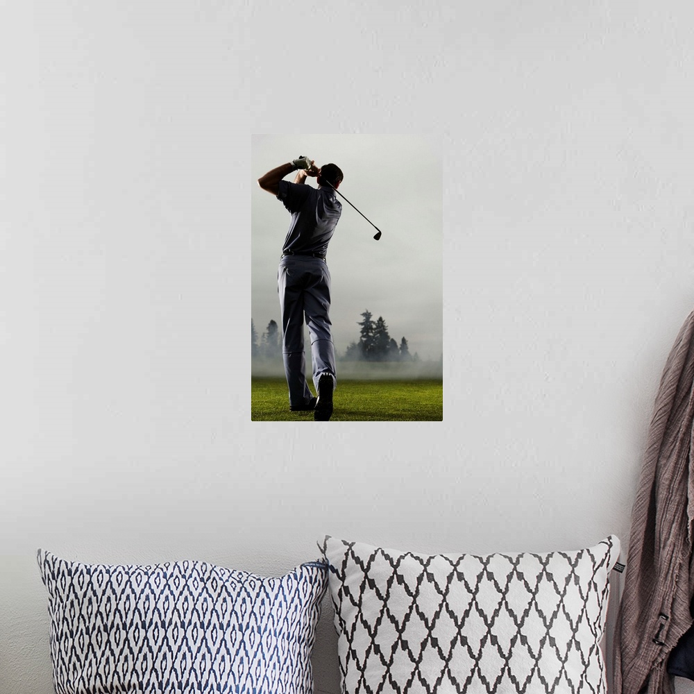 A bohemian room featuring Man playing golf, rear view