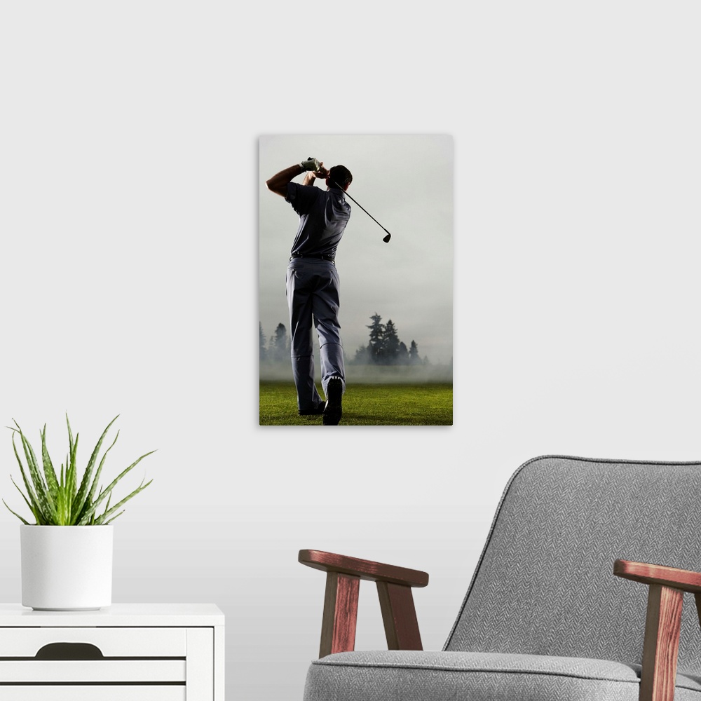 A modern room featuring Man playing golf, rear view
