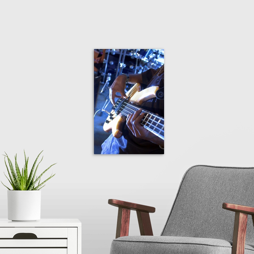 A modern room featuring Man playing guitar