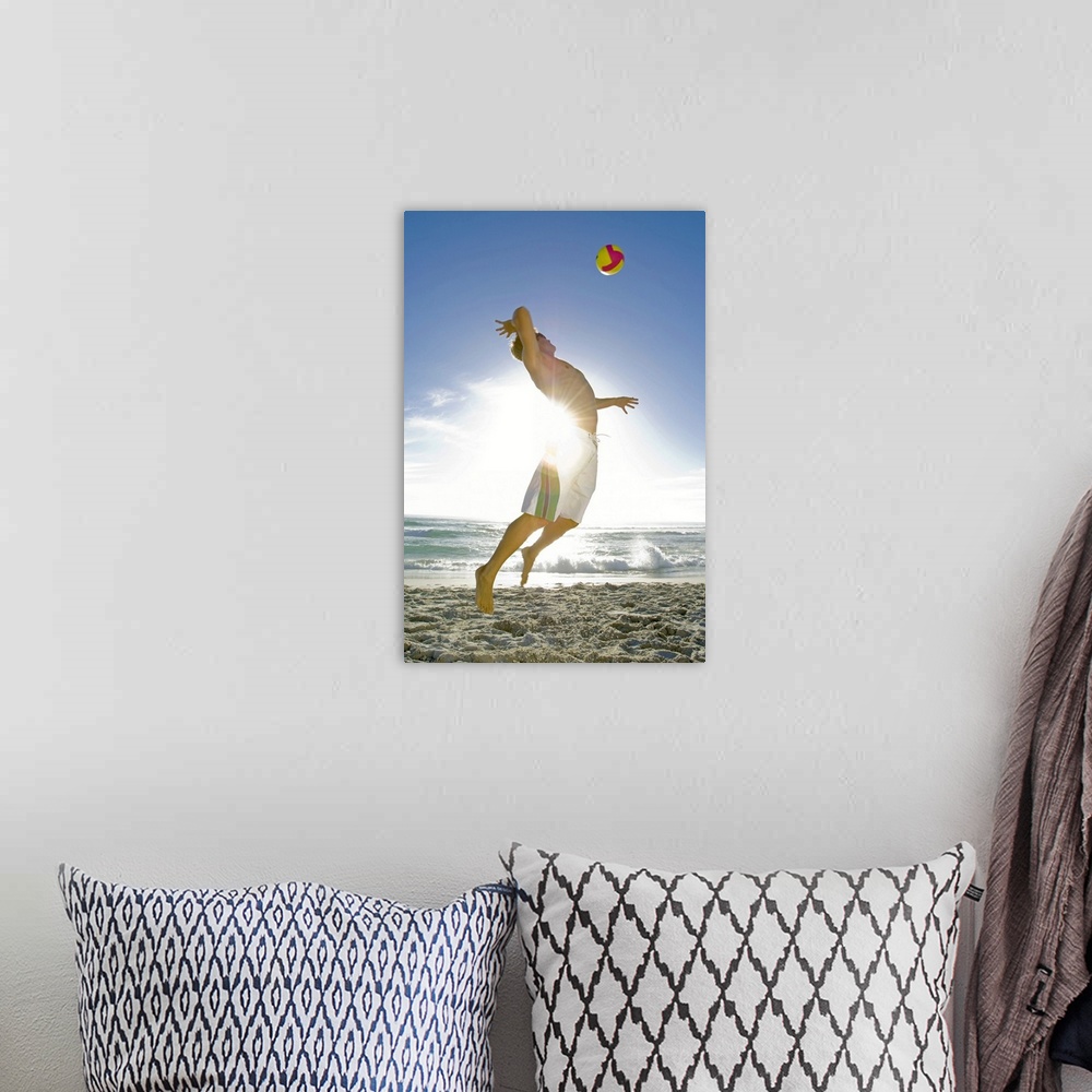 A bohemian room featuring Man playing volleyball on beach