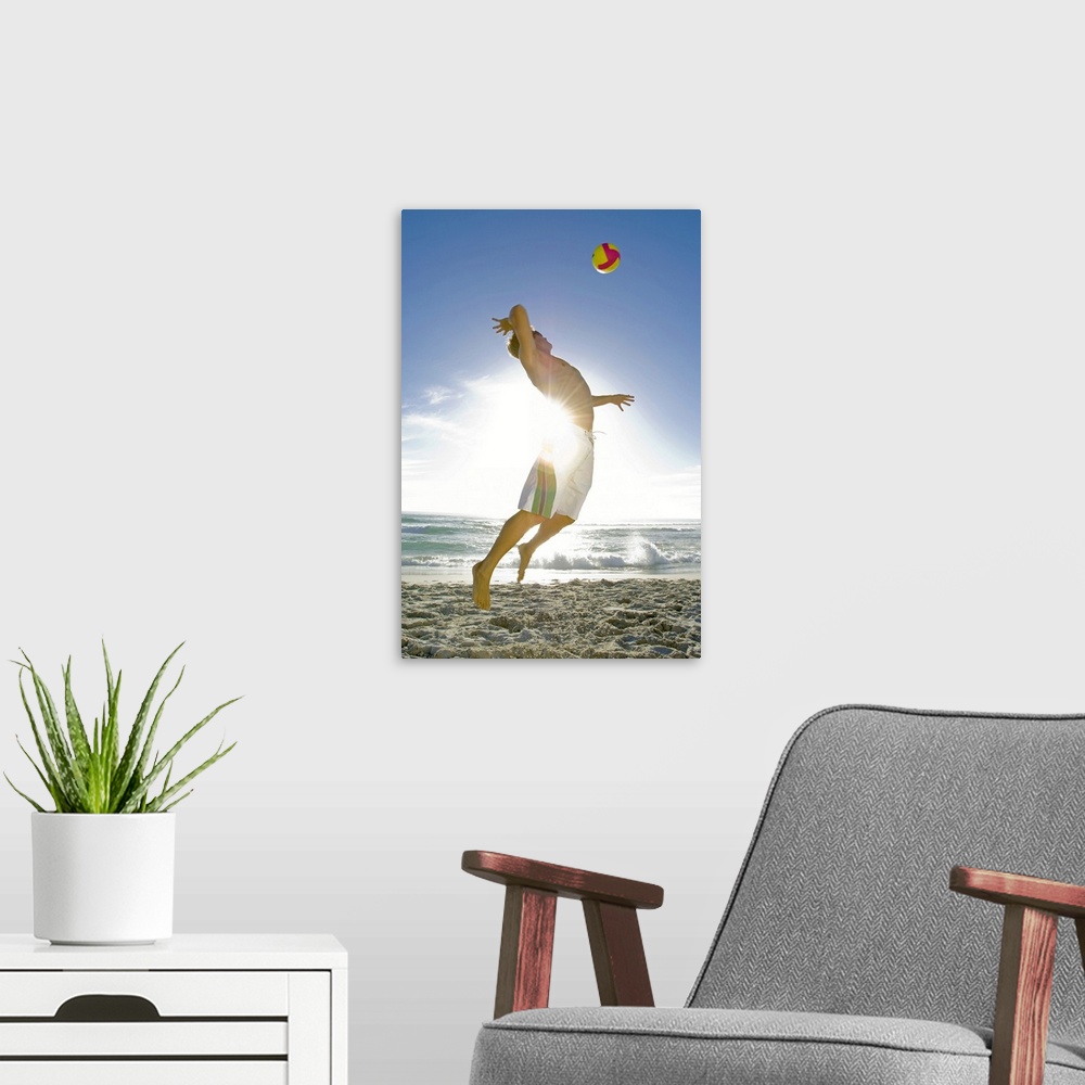 A modern room featuring Man playing volleyball on beach