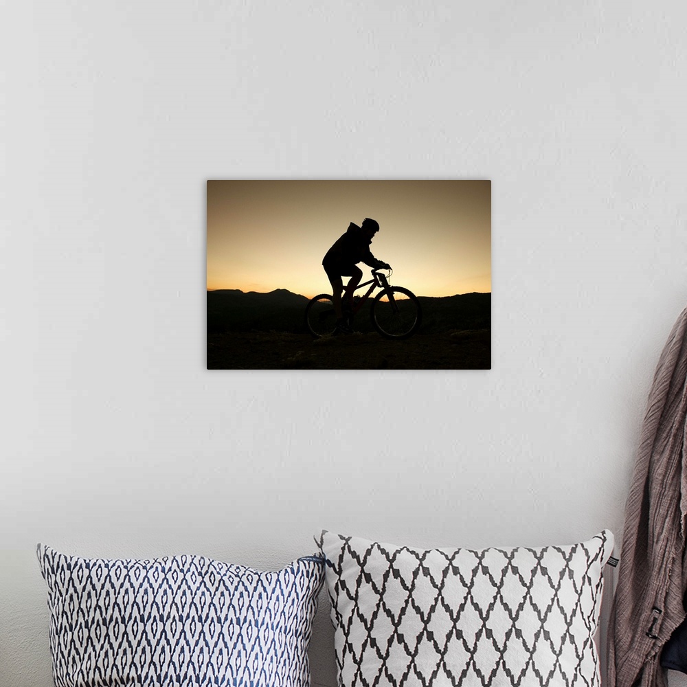 A bohemian room featuring Man riding bicycle