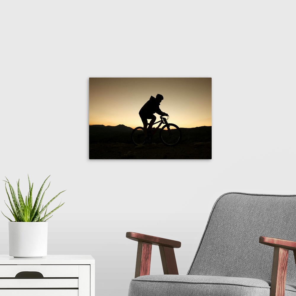 A modern room featuring Man riding bicycle