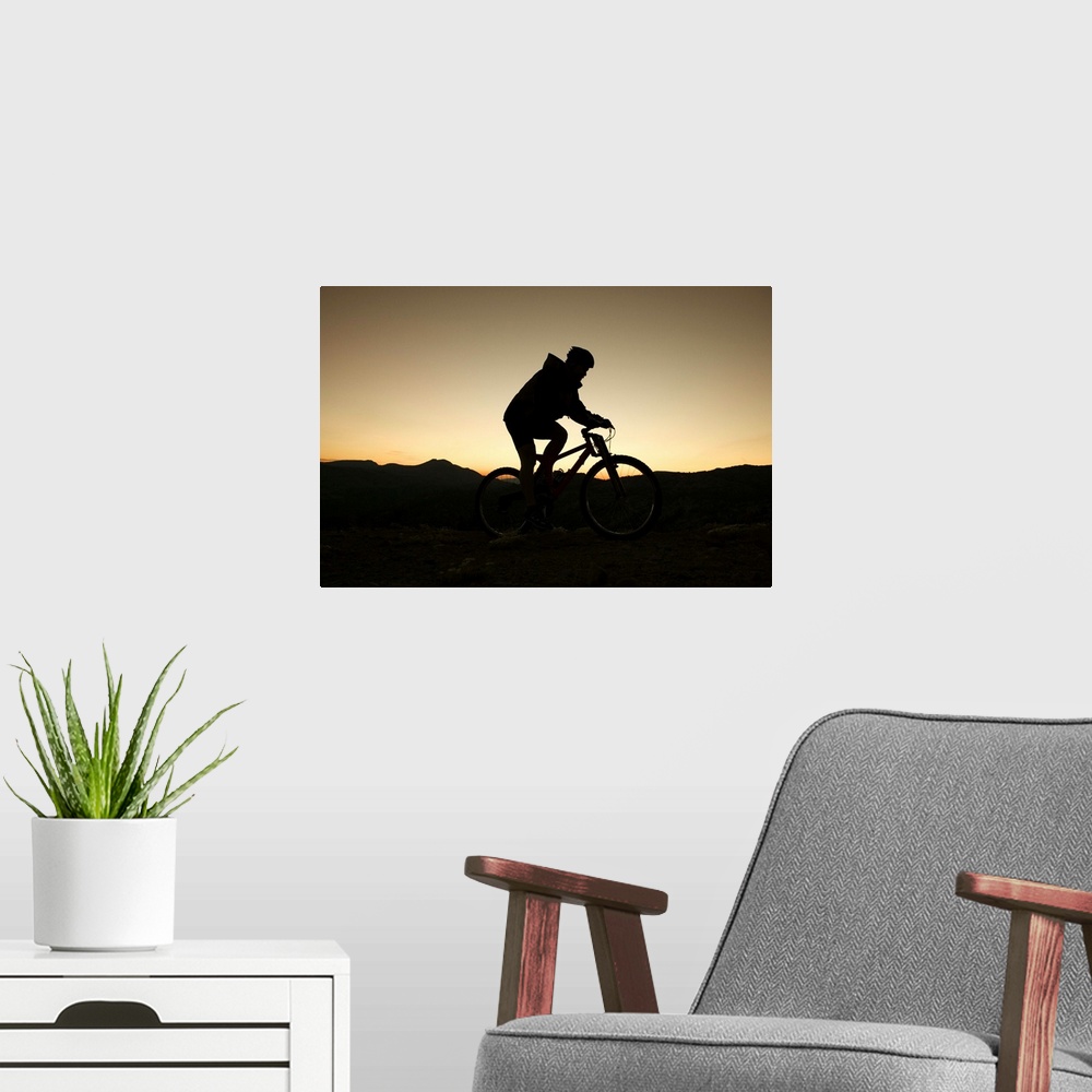 A modern room featuring Man riding bicycle