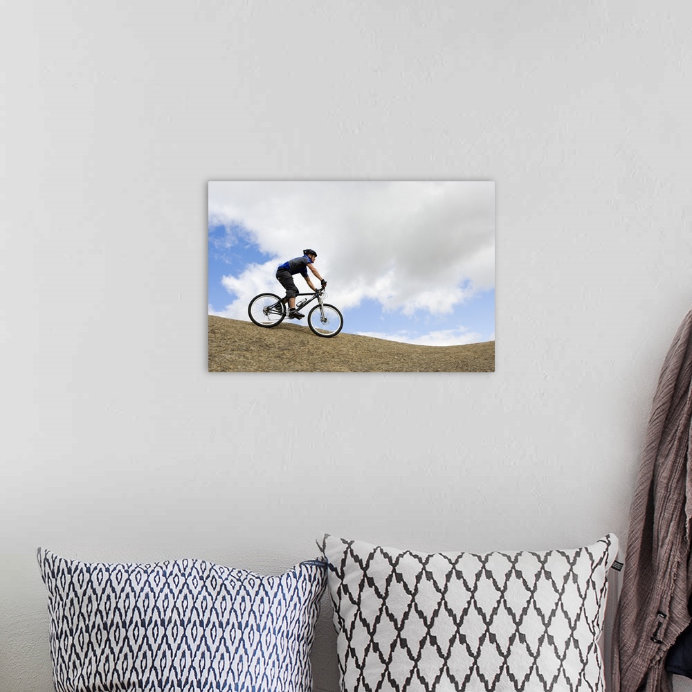 A bohemian room featuring Man riding mountain bike