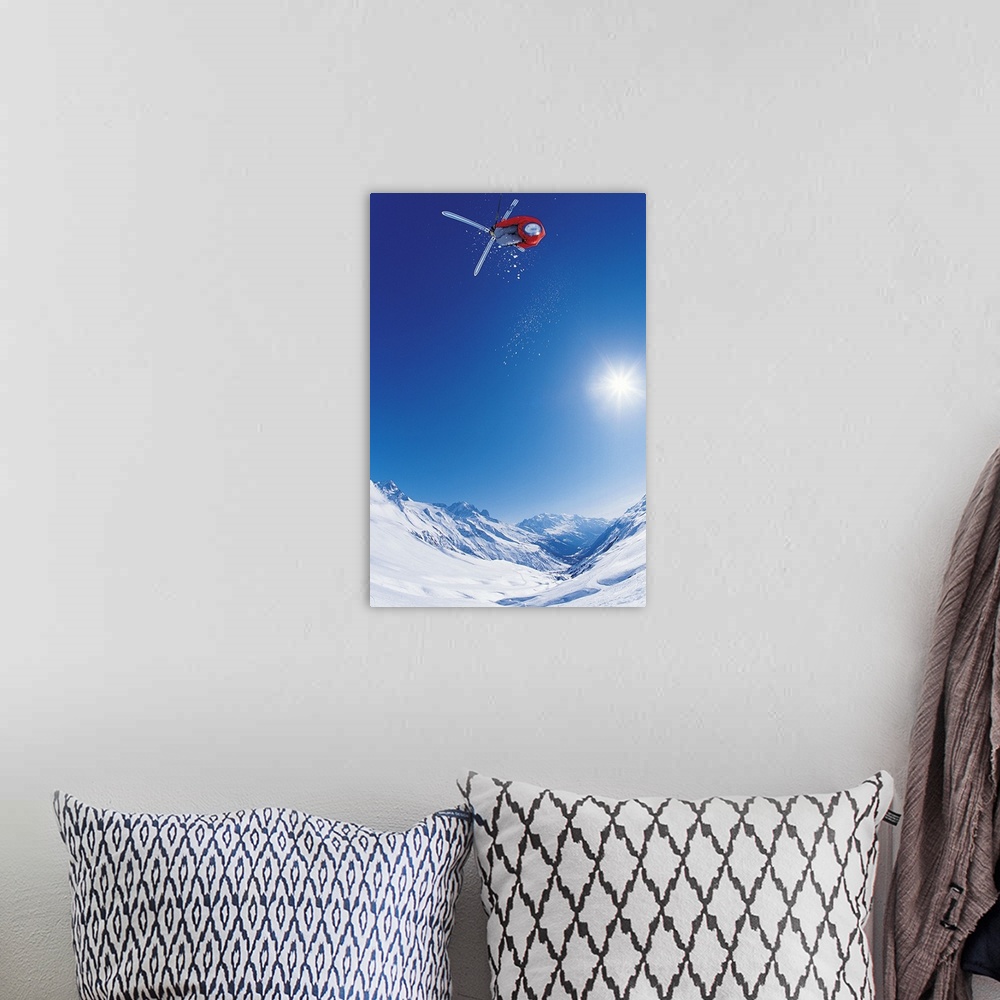 A bohemian room featuring Vertical photo of a man crossing his skis on as he flies through the air as the sun shines down o...
