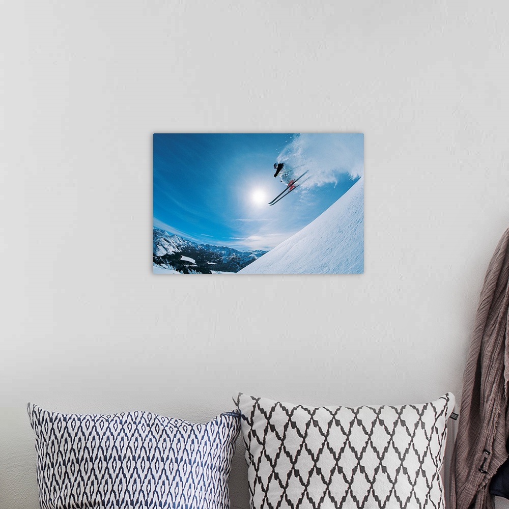 A bohemian room featuring Horizontal, photograph on large canvas of a skier making a jump down an angled slope, in mid-air,...