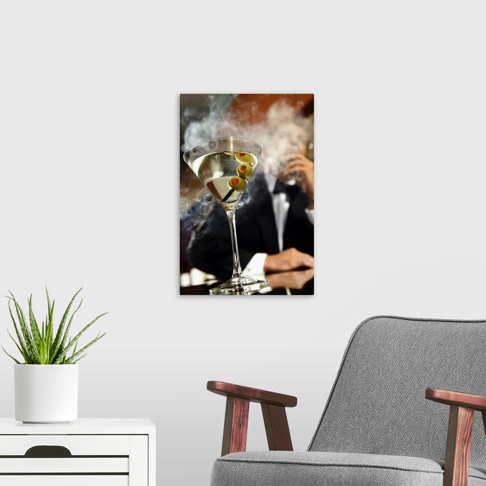 A modern room featuring Man smoking cigar with martini on bar