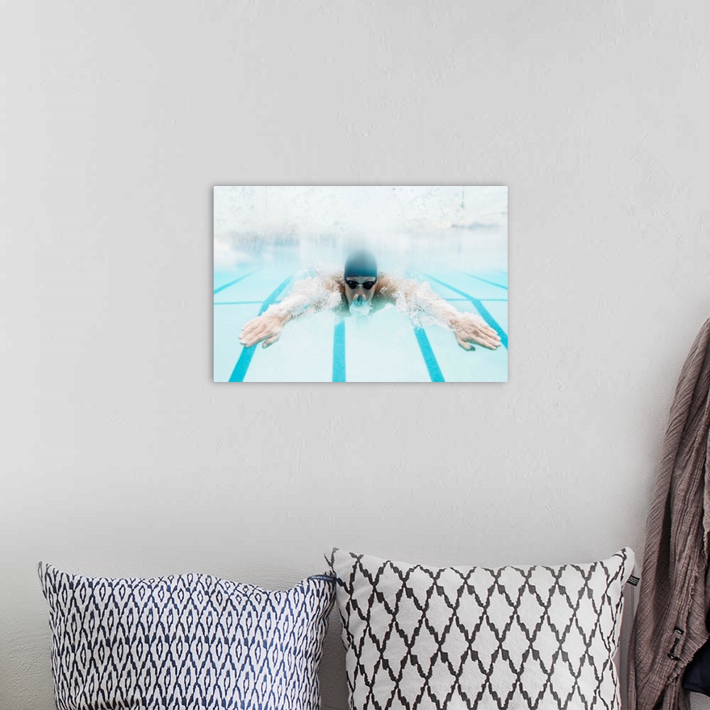 A bohemian room featuring Man swimming