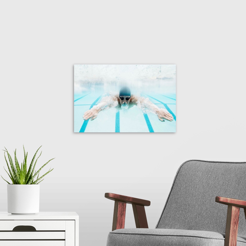 A modern room featuring Man swimming