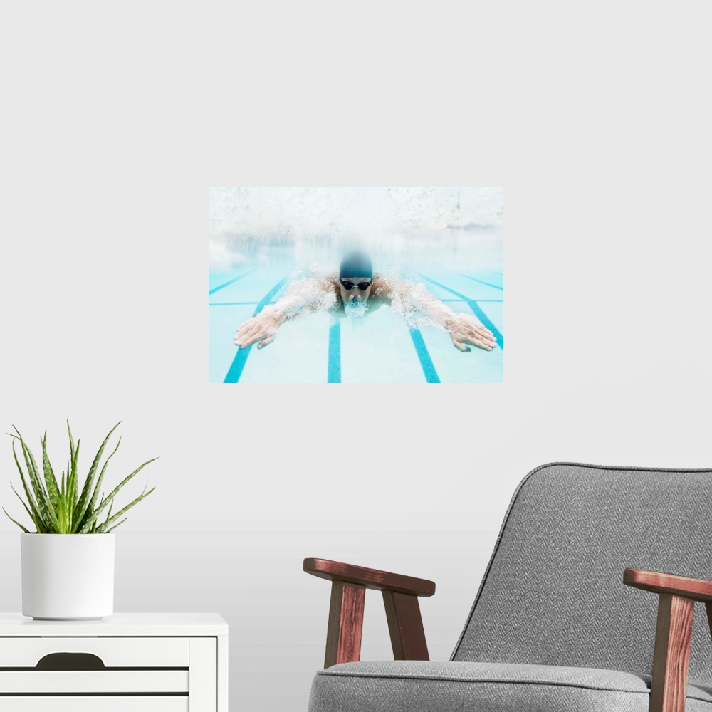A modern room featuring Man swimming