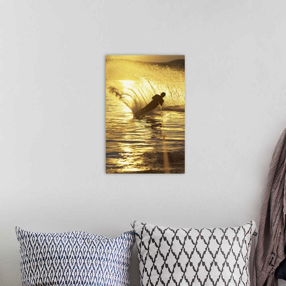 A bohemian room featuring Man water skiing at dusk