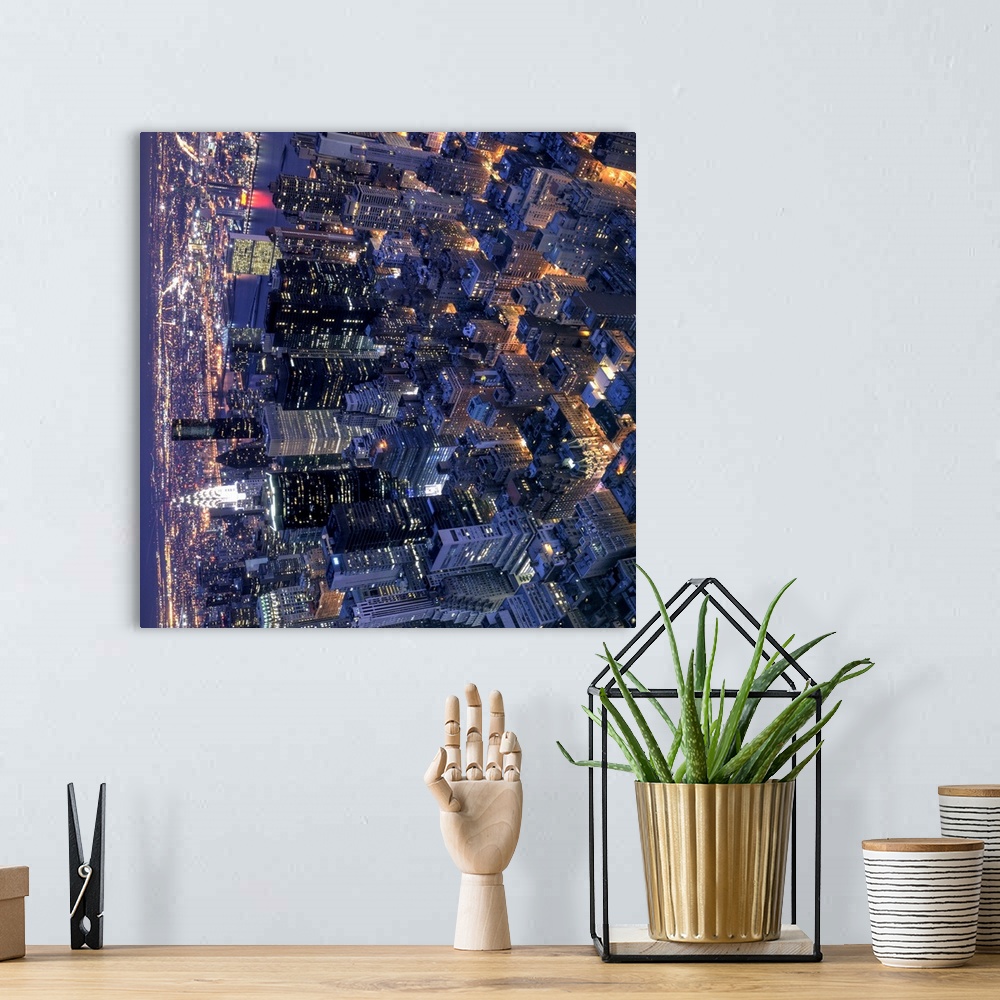 A bohemian room featuring New York, the city that never sleeps, with its streets and avenues glowing orange in the night. P...