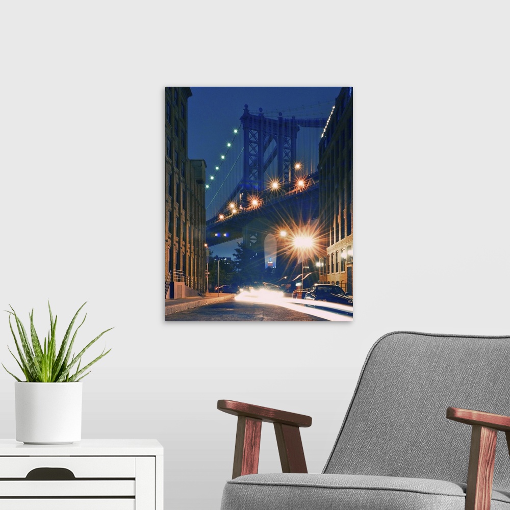 A modern room featuring Manhattan Bridge and Empire State Building at night.