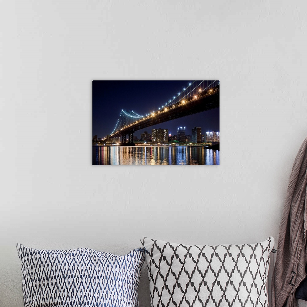 A bohemian room featuring USA, New York, Brooklyn, Manhattan Bridge at night reflected in East River with Empire State Buil...