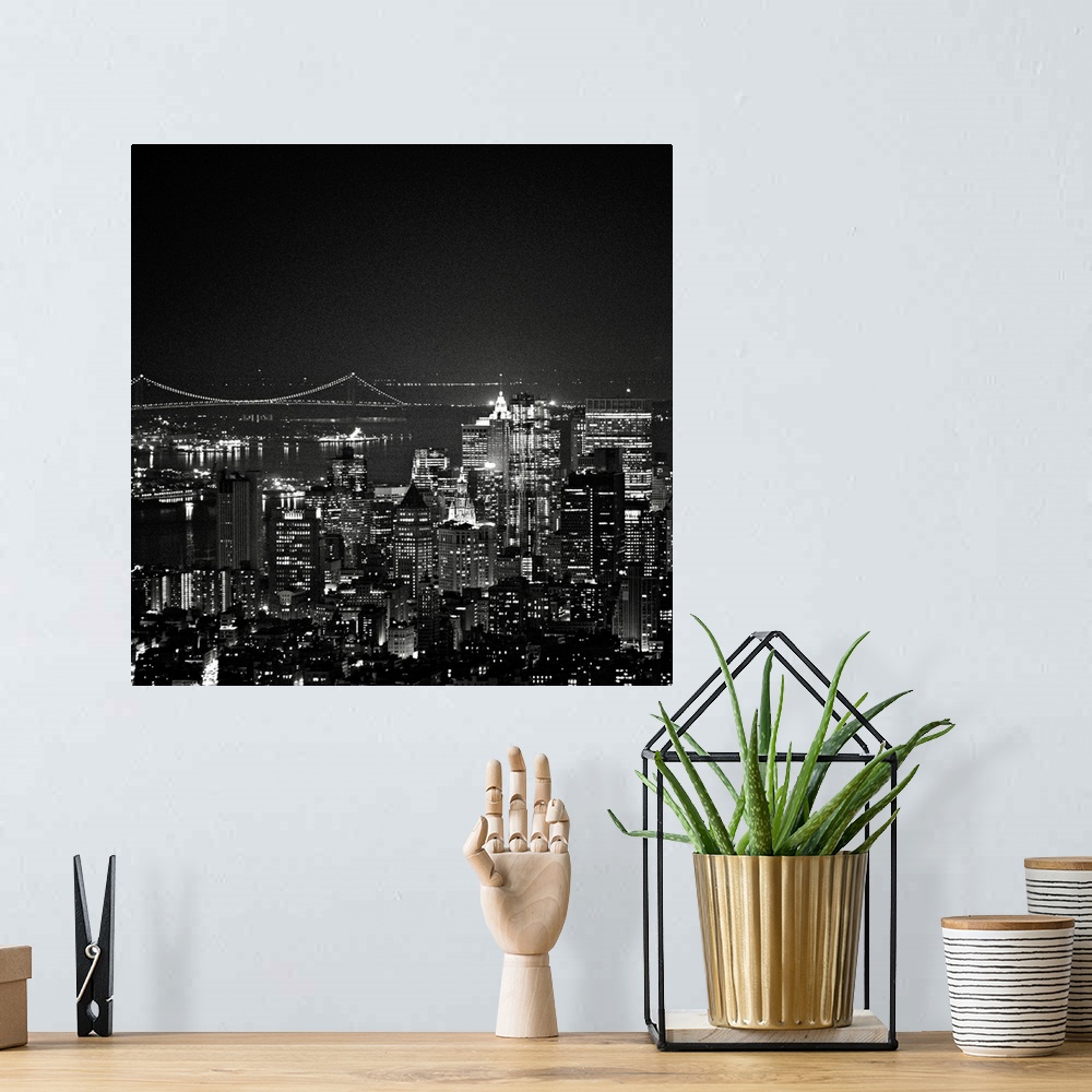 A bohemian room featuring This square piece is an aerial photograph taken of skyscrapers in New York illuminated under a da...