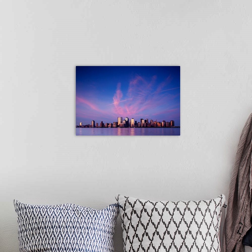 A bohemian room featuring USA, New York, New York City, Setting sun lights clouds above Manhattan skyline, viewed from New ...