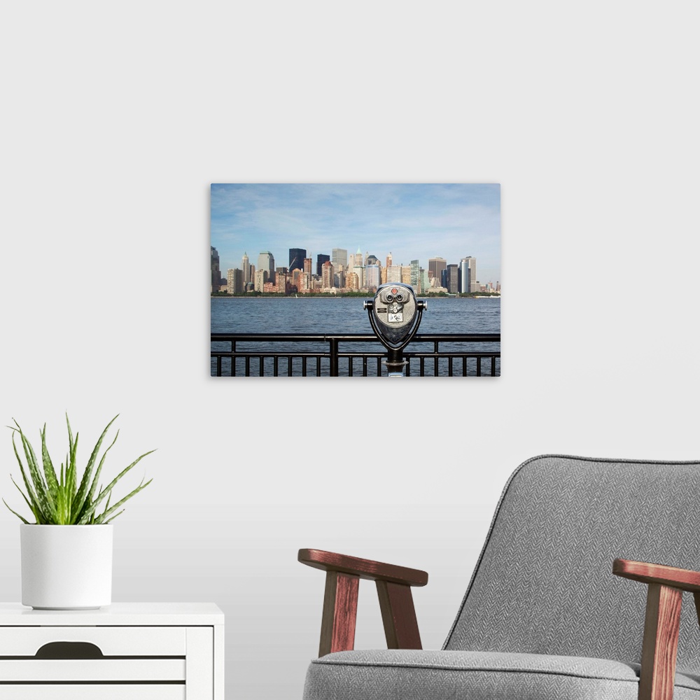 A modern room featuring USA, New Jersey, Jersey City, Coin operated binoculars pointed at Manhattan skyline rises from vi...