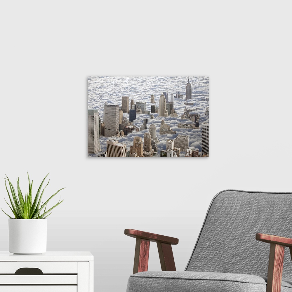 A modern room featuring Aerial photograph looking down on Manhattan, New York that is sitting in heavy fog and all you ca...