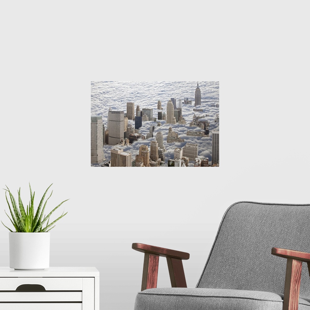 A modern room featuring Aerial photograph looking down on Manhattan, New York that is sitting in heavy fog and all you ca...