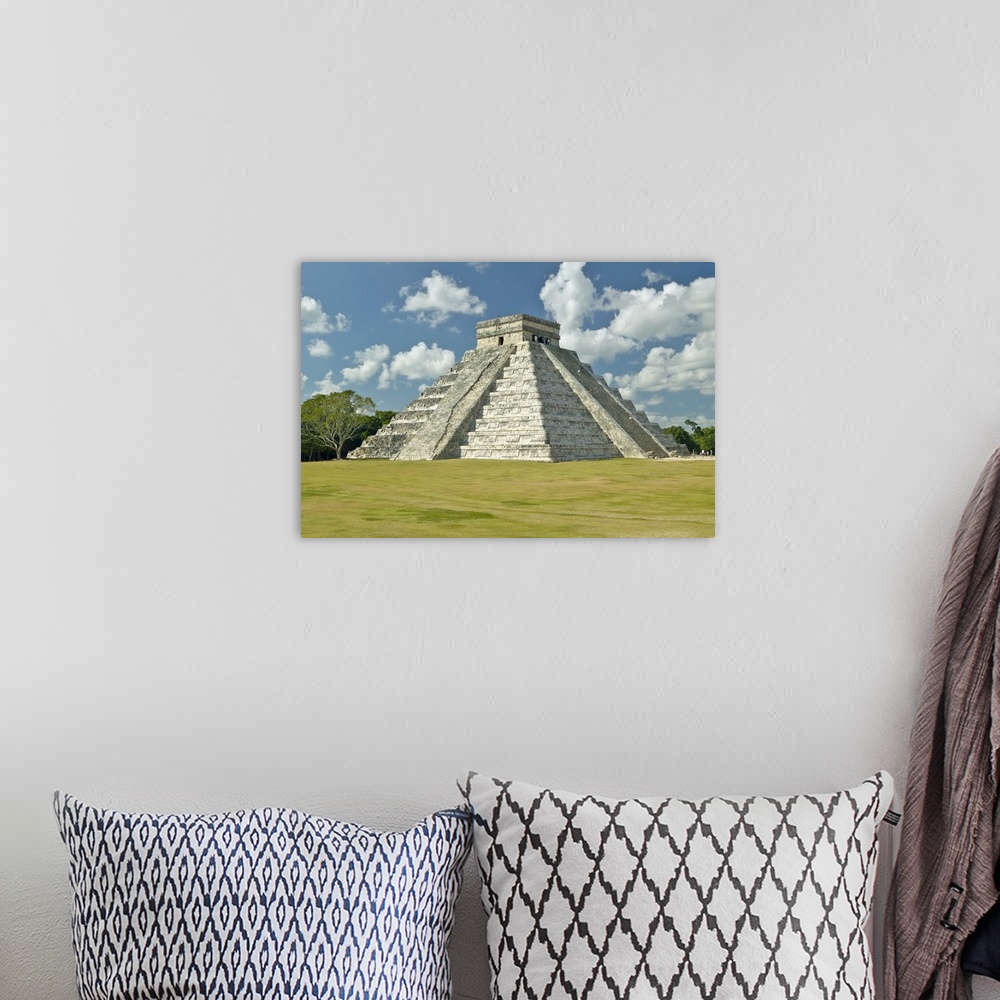 A bohemian room featuring White puffy clouds over the Mayan Pyramid of Kukulkan (also known as El Castillo) and ruins at Ch...