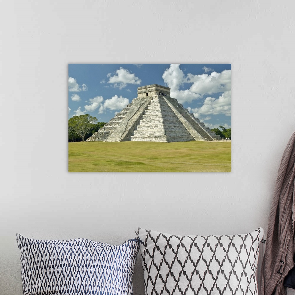 A bohemian room featuring White puffy clouds over the Mayan Pyramid of Kukulkan (also known as El Castillo) and ruins at Ch...