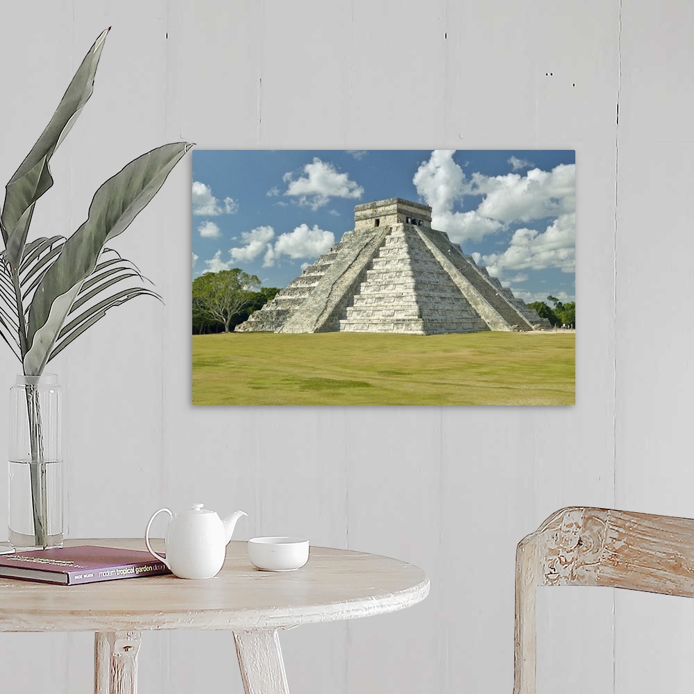 A farmhouse room featuring White puffy clouds over the Mayan Pyramid of Kukulkan (also known as El Castillo) and ruins at Ch...
