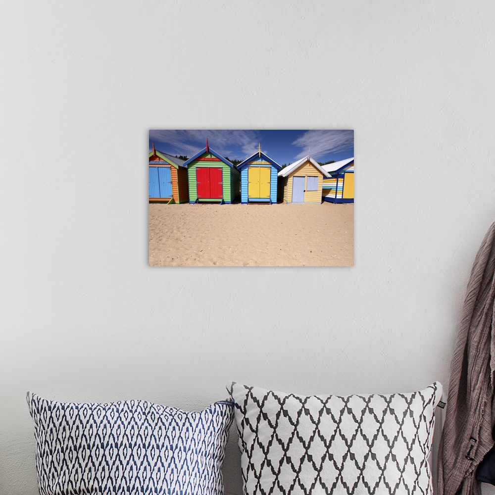 A bohemian room featuring Photograph of colorful shacks on the beach under a cloudy sky.