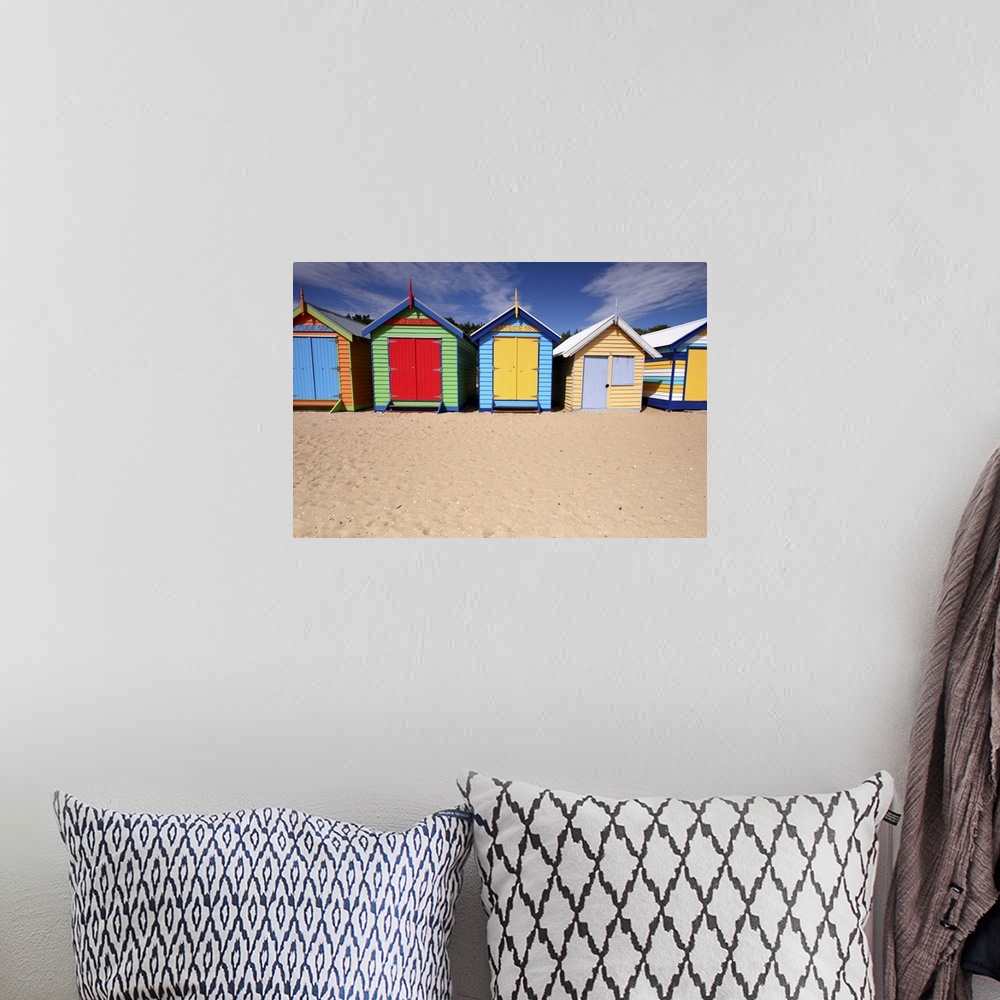 A bohemian room featuring Photograph of colorful shacks on the beach under a cloudy sky.