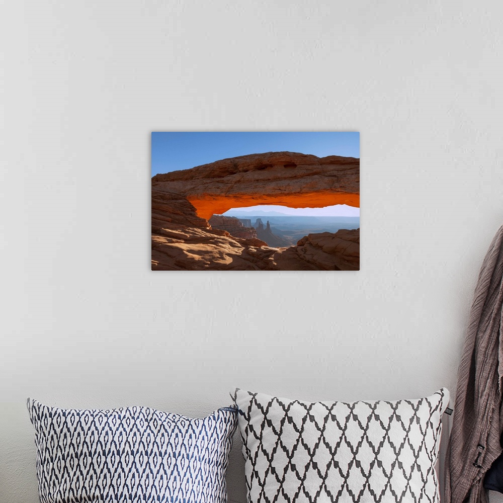 A bohemian room featuring Mesa Arch at sunrise, with Washer Woman Arch, Monster Tower and Airport Tower (Butte).  Canyonlan...