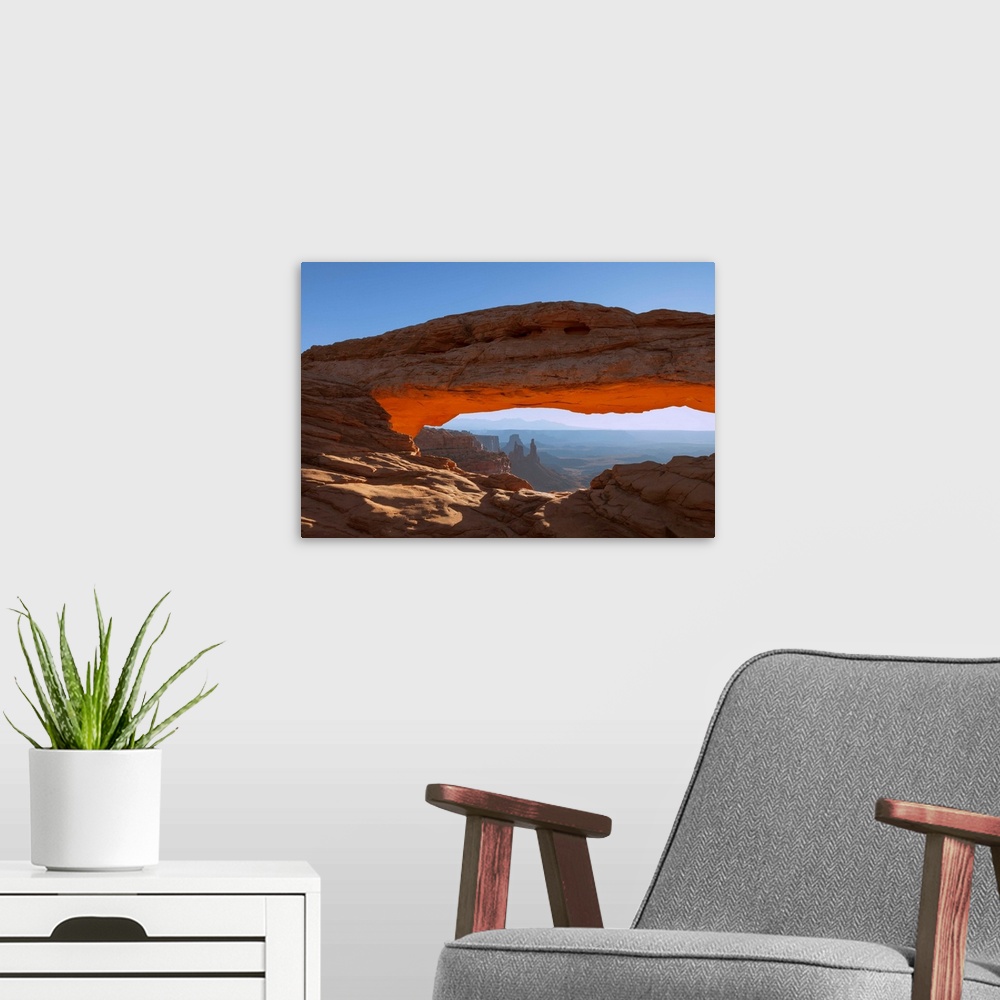A modern room featuring Mesa Arch at sunrise, with Washer Woman Arch, Monster Tower and Airport Tower (Butte).  Canyonlan...