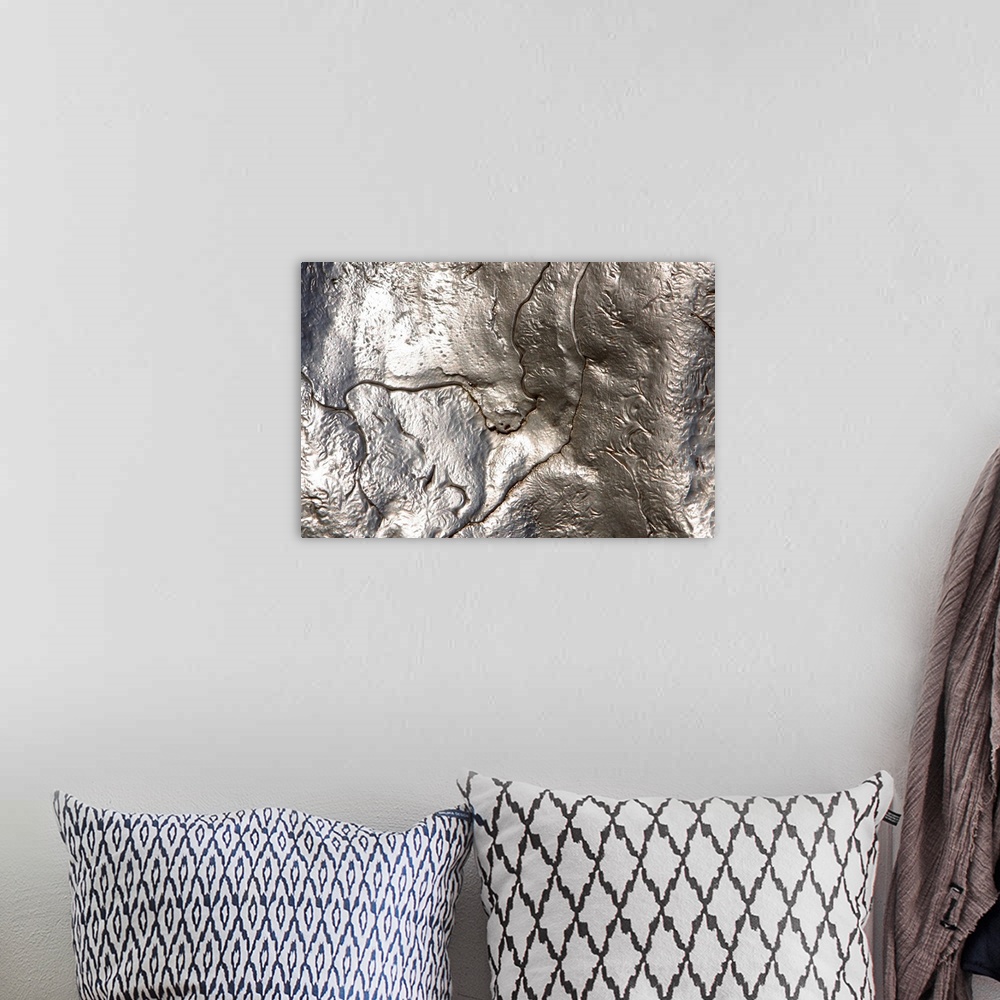 A bohemian room featuring Abstract artwork of a metallic silver object that has been photographed close up.