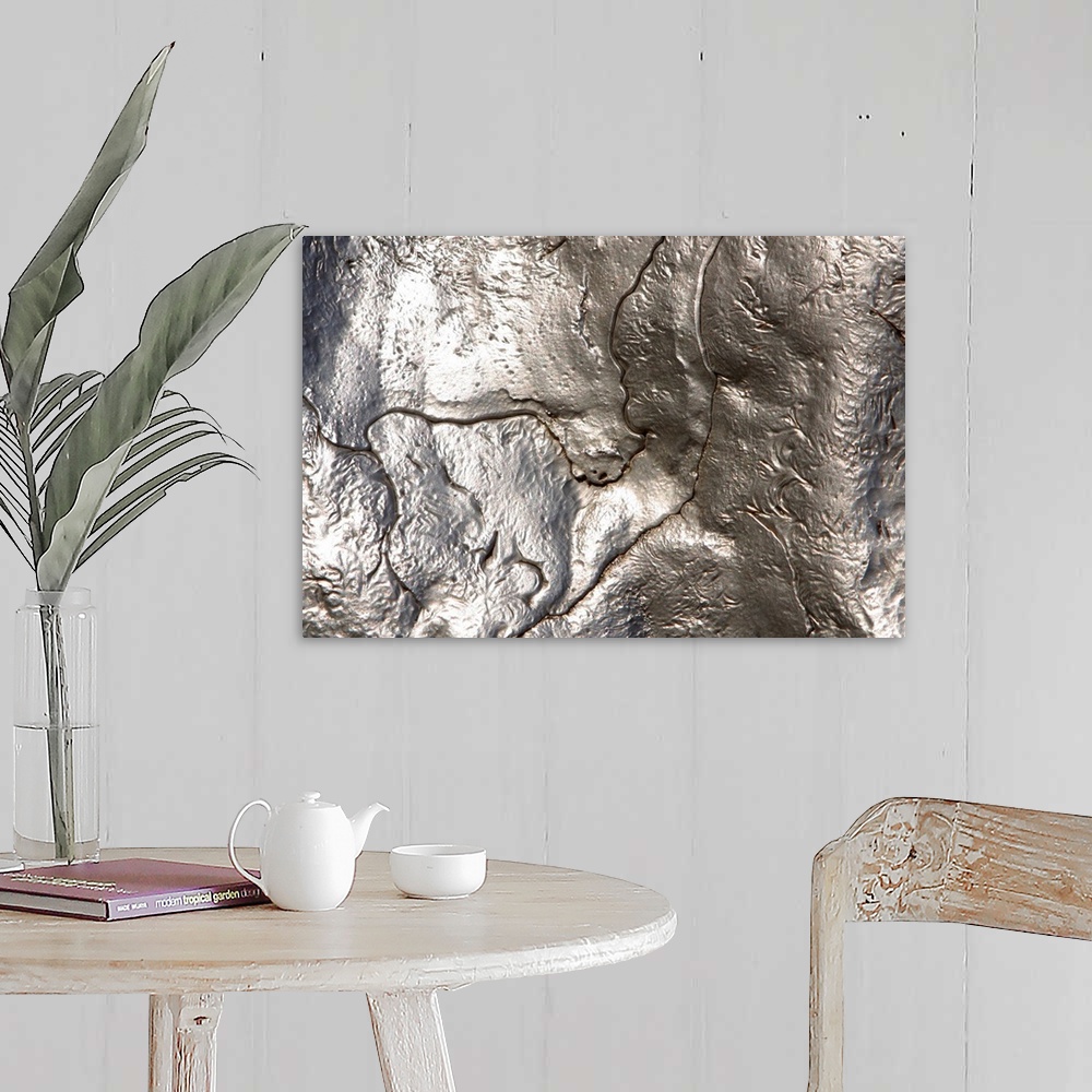 A farmhouse room featuring Abstract artwork of a metallic silver object that has been photographed close up.