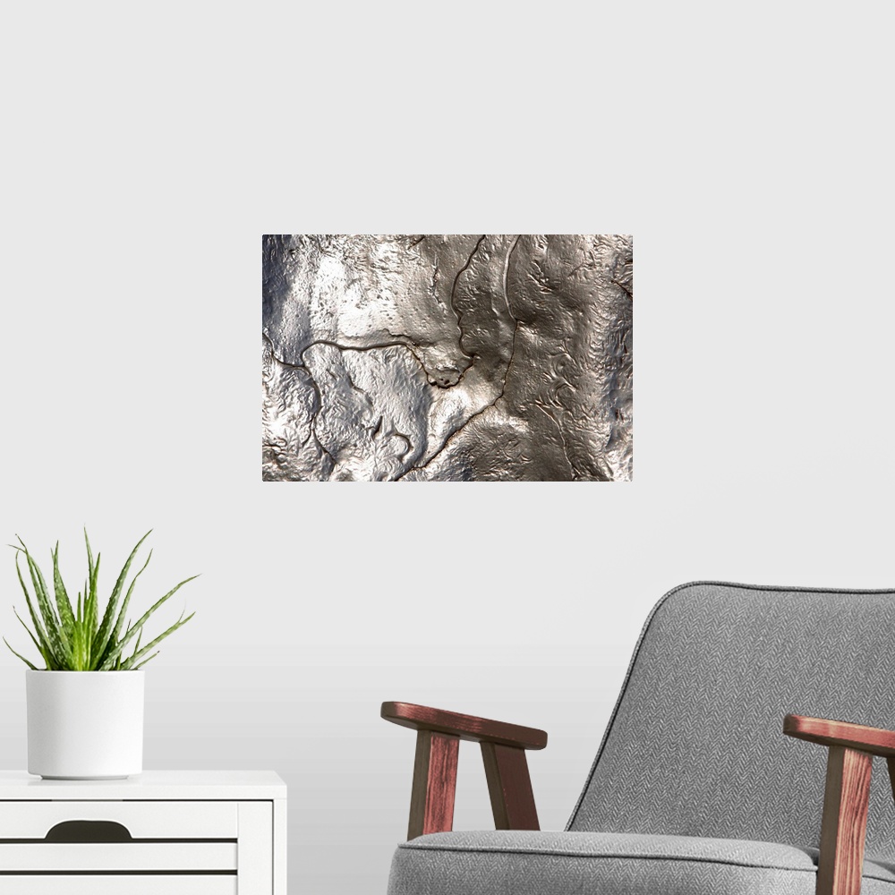 A modern room featuring Abstract artwork of a metallic silver object that has been photographed close up.