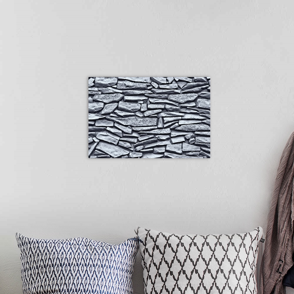 A bohemian room featuring Up close view of a Mexican rock wall printed on canvas.